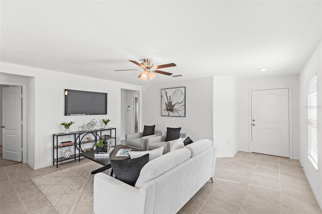 392 Kensington View Dr, Winter Haven, FL 33880 - living room featuring ceiling fan, baseboards, and light tile patterned floors