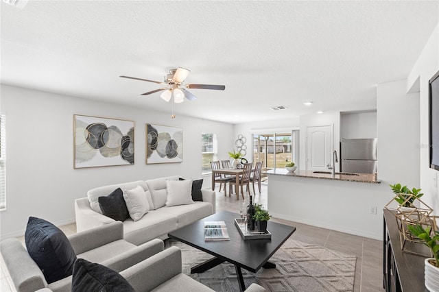 392 Kensington View Dr, Winter Haven, FL 33880 - living area with a textured ceiling, light tile patterned flooring, baseboards, recessed lighting, and a ceiling fan