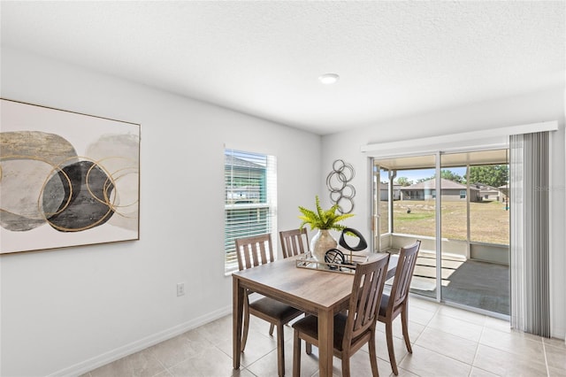 392 Kensington View Dr, Winter Haven, FL 33880 - dining room featuring light tile patterned flooring and baseboards