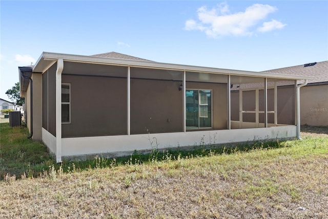 392 Kensington View Dr, Winter Haven, FL 33880 - rear view of property featuring a sunroom and stucco siding