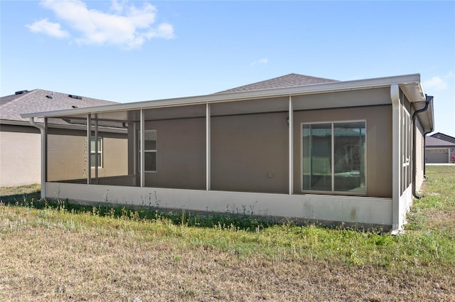 392 Kensington View Dr, Winter Haven, FL 33880 - view of side of home with a sunroom and stucco siding