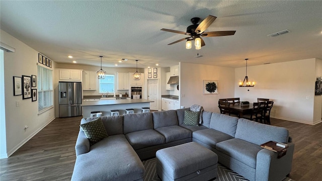 3330 Hanging Tide St, Winter Garden, FL 34787 - living area with recessed lighting, baseboards, dark wood-style flooring, and ceiling fan with notable chandelier