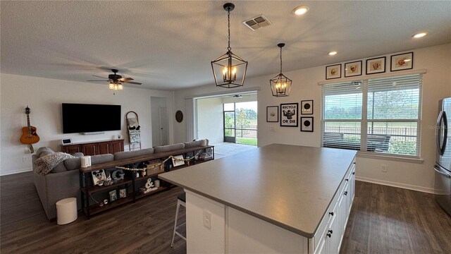 3330 Hanging Tide St, Winter Garden, FL 34787 - kitchen with ceiling fan, dark wood-style floors, white cabinetry, and visible vents