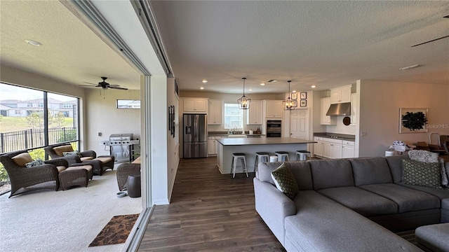 3330 Hanging Tide St, Winter Garden, FL 34787 - living area featuring a textured ceiling, recessed lighting, ceiling fan, and dark wood-style flooring