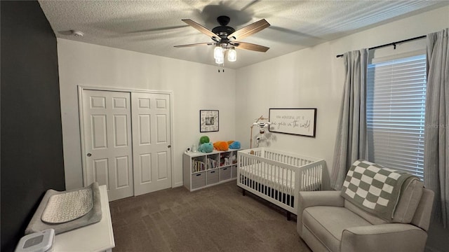 3330 Hanging Tide St, Winter Garden, FL 34787 - carpeted bedroom featuring a nursery area, a textured ceiling, ceiling fan, and a closet