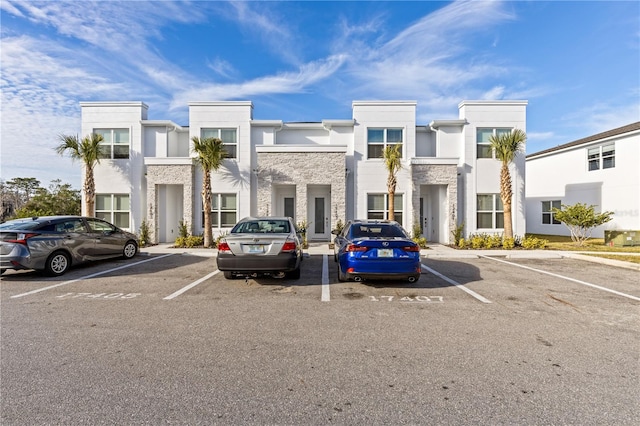view of building exterior featuring uncovered parking
