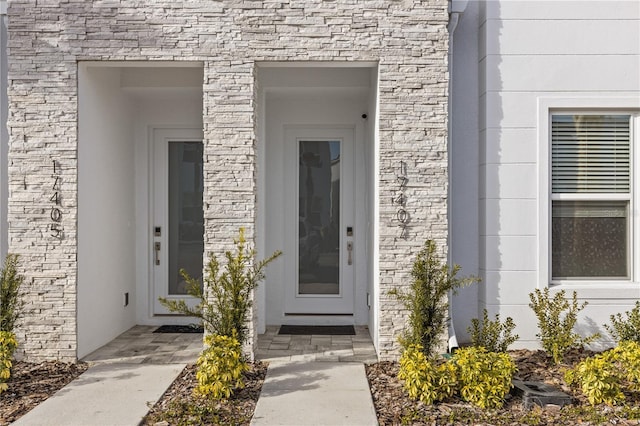property entrance with stone siding