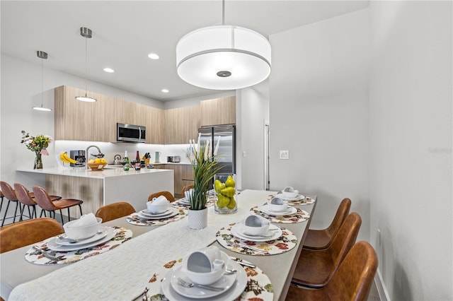 dining area featuring recessed lighting and baseboards