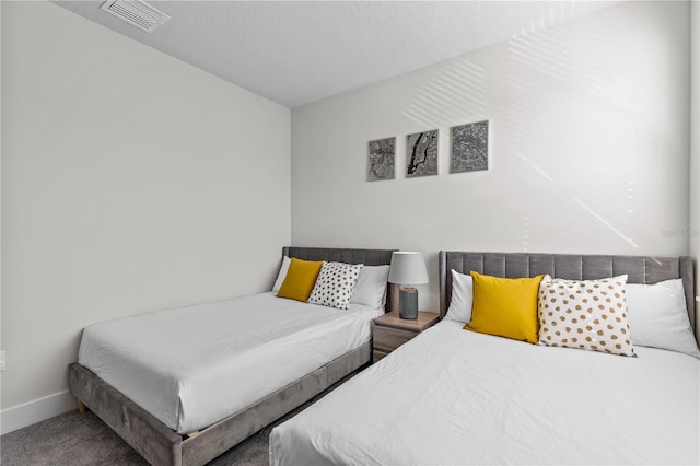 bedroom with baseboards, carpet floors, and visible vents