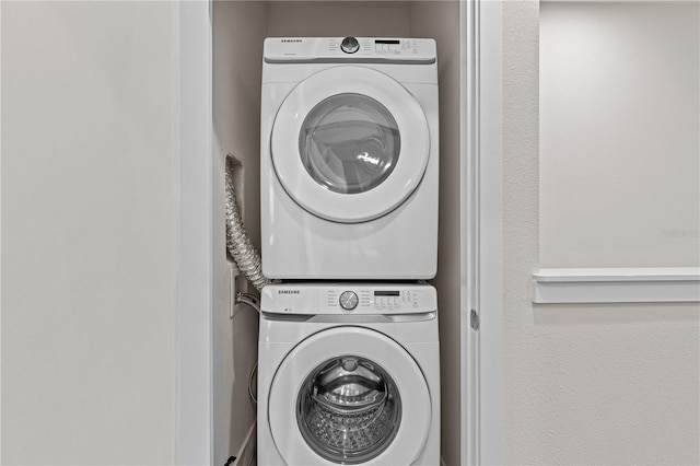 laundry area featuring laundry area and stacked washer / dryer