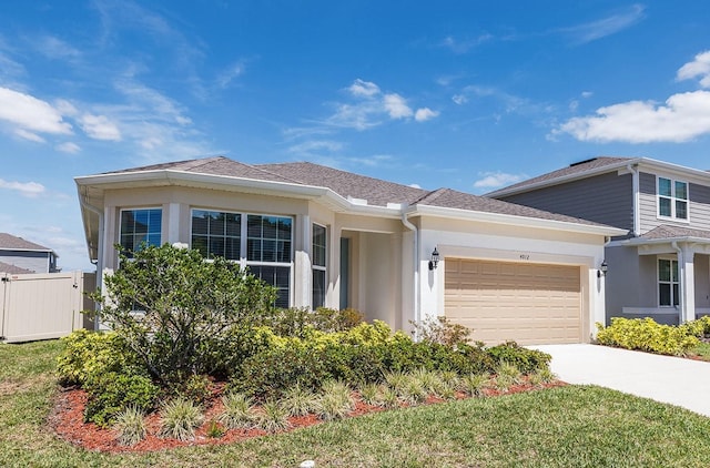 4012 Meandering Bay Dr, Apopka, FL 32712 - view of front of home with a garage, stucco siding, and driveway