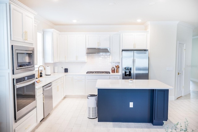 4012 Meandering Bay Dr, Apopka, FL 32712 - kitchen featuring stainless steel appliances, under cabinet range hood, a center island, a sink, and tasteful backsplash