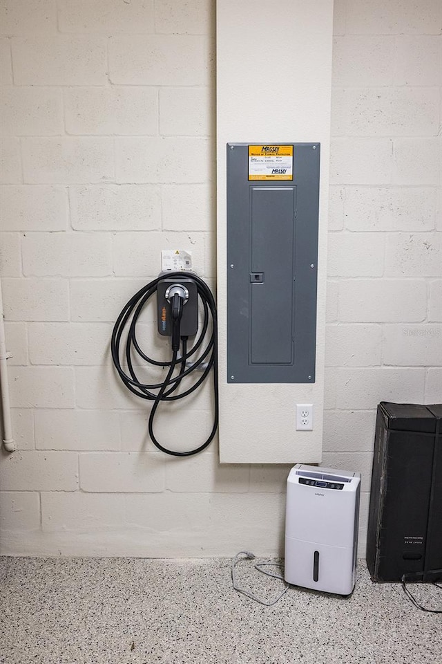4012 Meandering Bay Dr, Apopka, FL 32712 - detailed view of electric panel, speckled floor, and concrete block wall