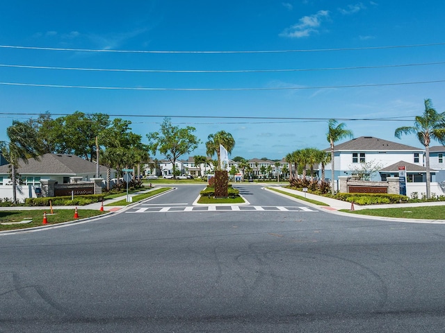 4012 Meandering Bay Dr, Apopka, FL 32712 - view of asphalt road featuring a residential view, sidewalks, and curbs