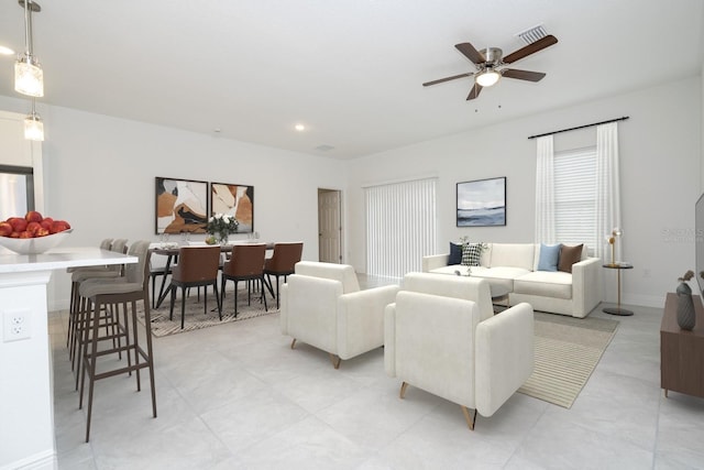 living area with recessed lighting, visible vents, baseboards, and ceiling fan