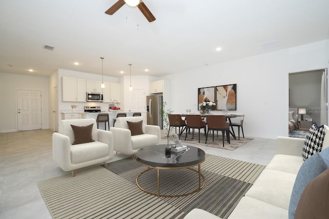 living room with visible vents, ceiling fan, and recessed lighting