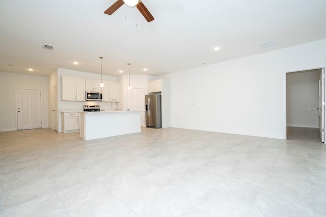 unfurnished living room with recessed lighting, visible vents, a sink, and a ceiling fan