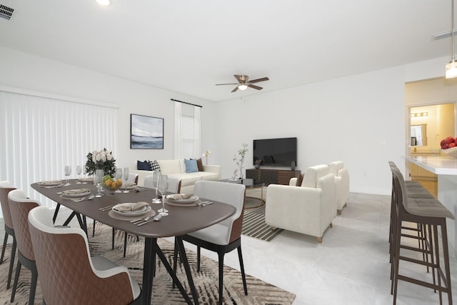 dining room featuring baseboards, a ceiling fan, and visible vents
