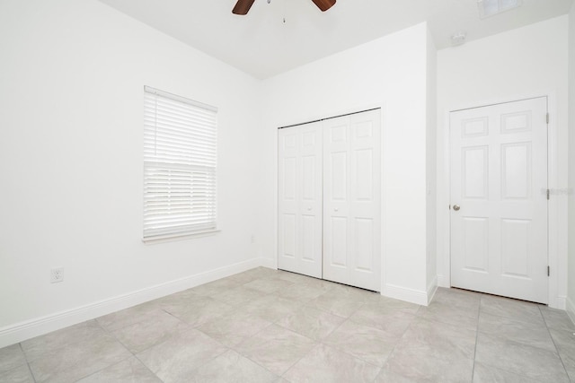 unfurnished bedroom featuring visible vents, a closet, baseboards, and ceiling fan