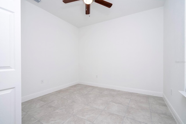 spare room featuring ceiling fan and baseboards