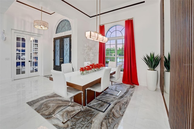 dining room with french doors, baseboards, and an inviting chandelier