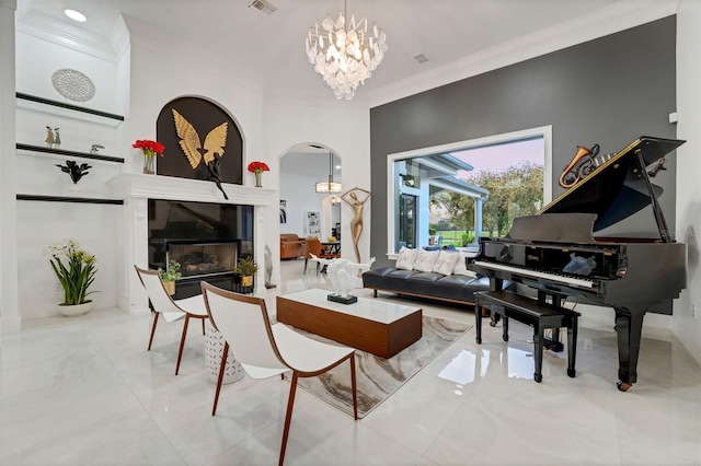 living area featuring a glass covered fireplace, a notable chandelier, ornamental molding, visible vents, and arched walkways