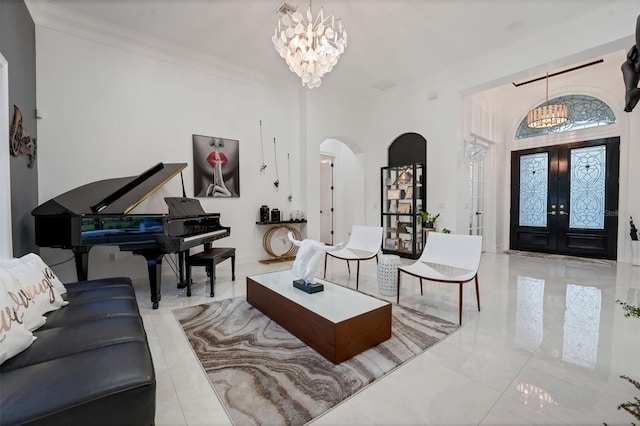 living room featuring baseboards, an inviting chandelier, french doors, crown molding, and arched walkways