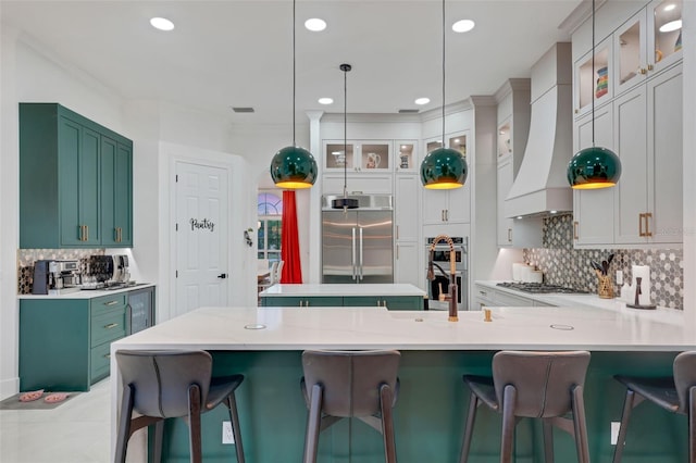 kitchen with stainless steel appliances, a peninsula, premium range hood, and decorative backsplash