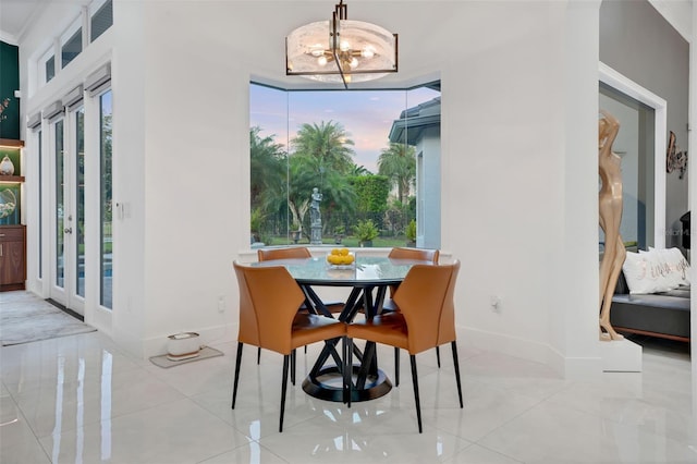 dining room featuring baseboards and an inviting chandelier