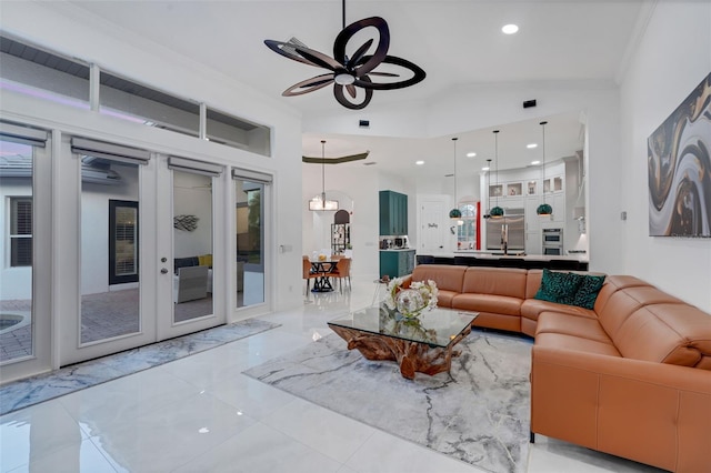 living area with recessed lighting, french doors, crown molding, lofted ceiling, and ceiling fan
