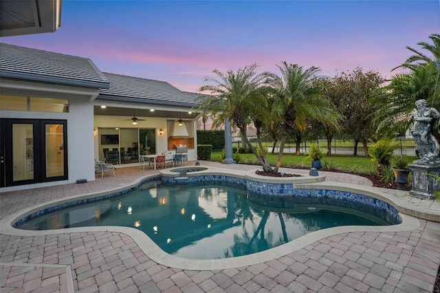 outdoor pool featuring a patio, an outdoor kitchen, fence, and a ceiling fan