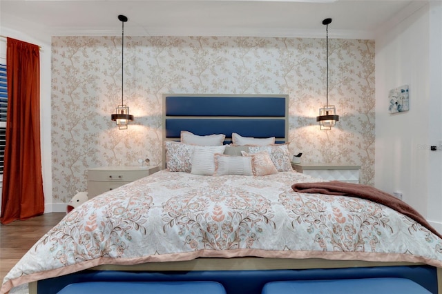 bedroom with crown molding, baseboards, wood finished floors, and wallpapered walls