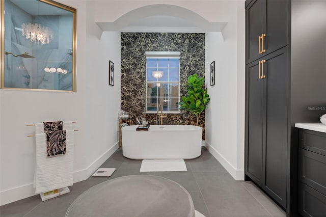 full bath with a soaking tub, a walk in shower, baseboards, and tile patterned flooring