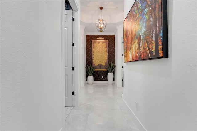 corridor with baseboards and an inviting chandelier
