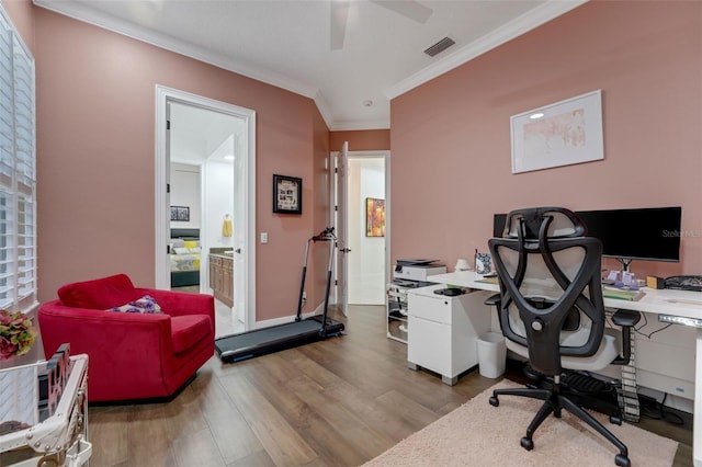 home office with ceiling fan, ornamental molding, visible vents, wood finished floors, and baseboards