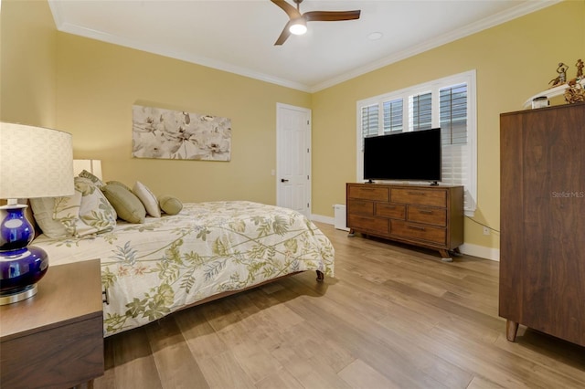 bedroom featuring ornamental molding, baseboards, ceiling fan, and wood finished floors