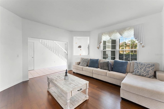 219 Strathmore Cir, Kissimmee, FL 34744 - living room with dark wood-type flooring, stairway, and baseboards