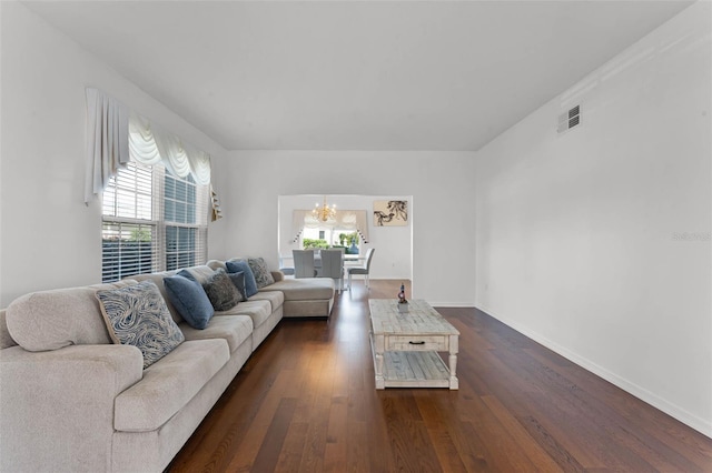 219 Strathmore Cir, Kissimmee, FL 34744 - living area featuring baseboards, visible vents, an inviting chandelier, and dark wood-type flooring