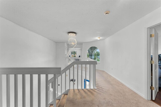 219 Strathmore Cir, Kissimmee, FL 34744 - hallway featuring carpet floors, baseboards, and an upstairs landing