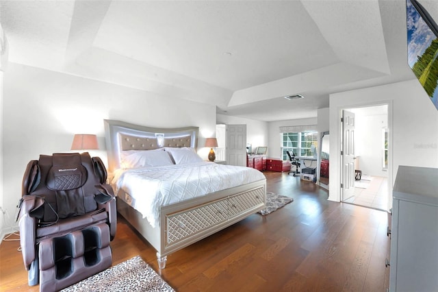 219 Strathmore Cir, Kissimmee, FL 34744 - bedroom featuring a raised ceiling, wood finished floors, and visible vents