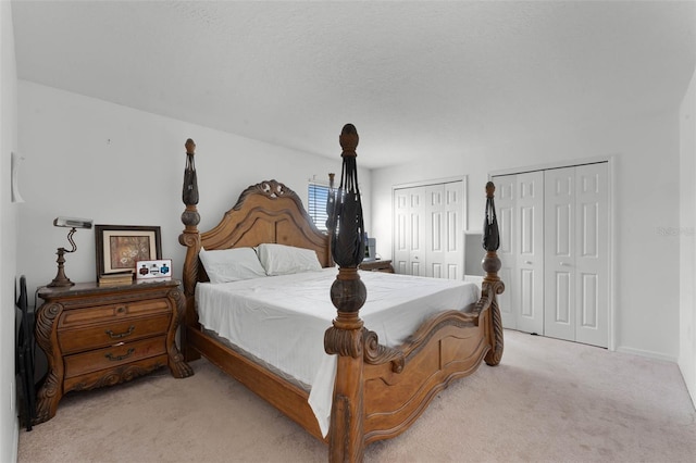 219 Strathmore Cir, Kissimmee, FL 34744 - bedroom featuring two closets and light carpet