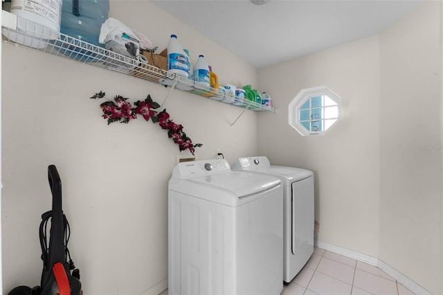 219 Strathmore Cir, Kissimmee, FL 34744 - laundry room featuring baseboards, light tile patterned flooring, laundry area, and independent washer and dryer