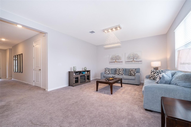 living area featuring visible vents, baseboards, and light carpet