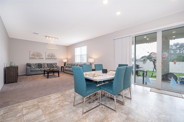 dining space featuring light carpet and visible vents