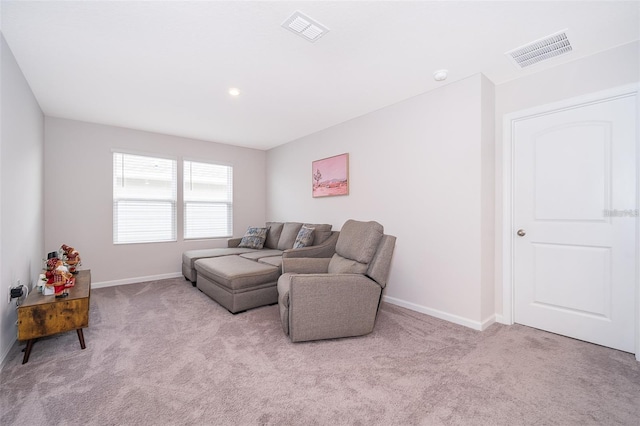 carpeted living room featuring visible vents and baseboards