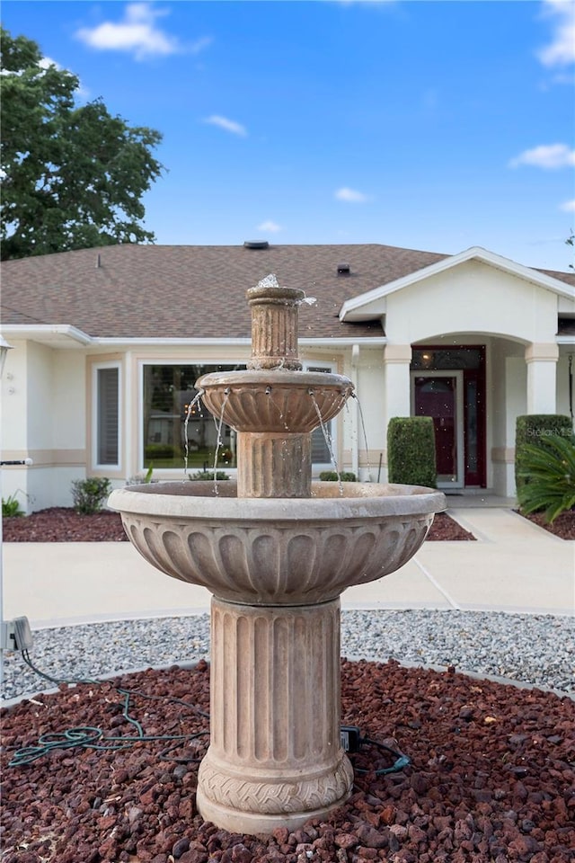 26901 Racquet Cir, Leesburg, FL 34748 - exterior space featuring stucco siding and roof with shingles