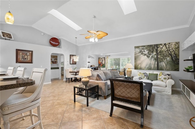26901 Racquet Cir, Leesburg, FL 34748 - living room featuring light tile patterned floors, a skylight, arched walkways, and a ceiling fan