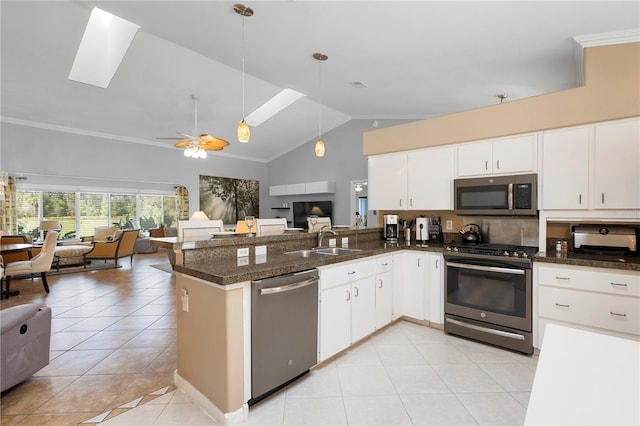 26901 Racquet Cir, Leesburg, FL 34748 - kitchen featuring a sink, appliances with stainless steel finishes, open floor plan, light tile patterned flooring, and a skylight