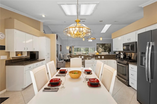 26901 Racquet Cir, Leesburg, FL 34748 - kitchen featuring white cabinets, stainless steel appliances, an inviting chandelier, and light tile patterned flooring