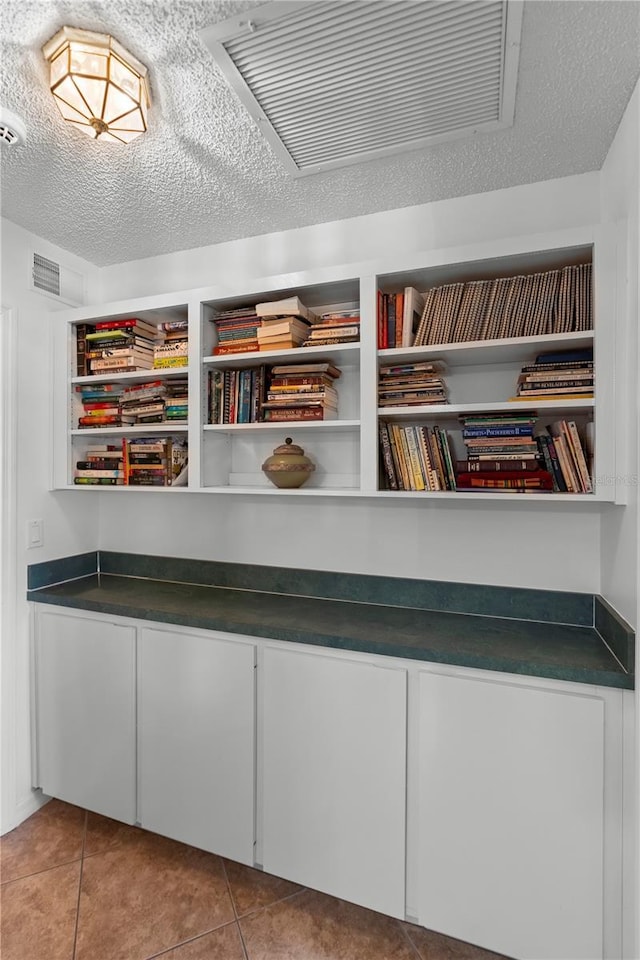 26901 Racquet Cir, Leesburg, FL 34748 - interior space with a textured ceiling and tile patterned flooring